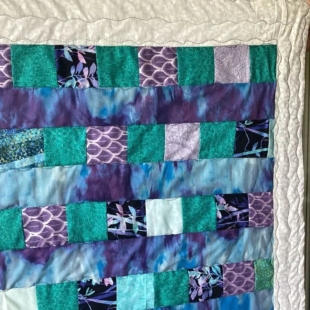 NWT. Hand Crafted Patchwork Quilt with Blues, Purples and Teals Accents